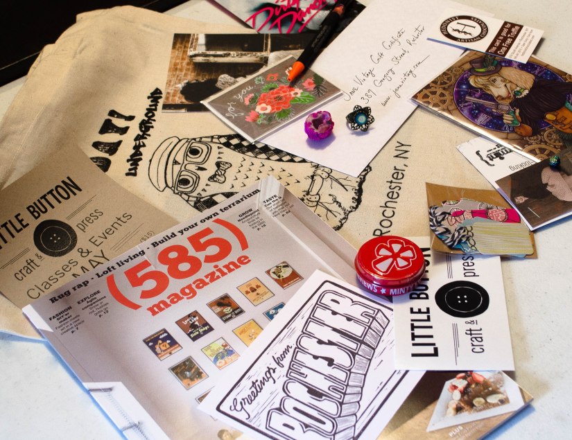 Lots of goodies including a 585 magazine, earrings from Peppermint, little treats from Prismatic Gardens, rings from Sunshyne Silverwear, free truffle coupon from Hedonist, notecards from Fawnsberg and Carrie Lindstrom, hand stamped postcard from Jackbear Stamps, cute tags from Making the Nest of It, plus lots more are in the swag bags this spring. To top it off, everything comes bundled in a limited-edition screen printed Mayday! Underground canvas tote bag!